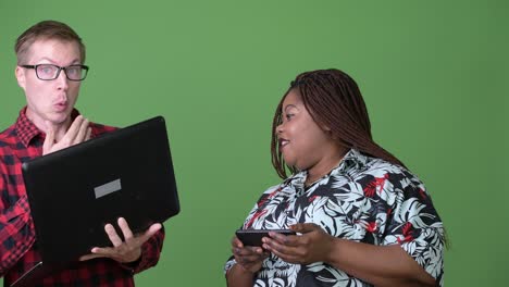 overweight african woman and young scandinavian man together against green background