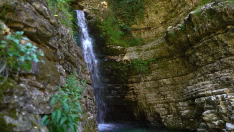 peaceful hidden spot inside canyon with waterfall water splashing on rocks in albania