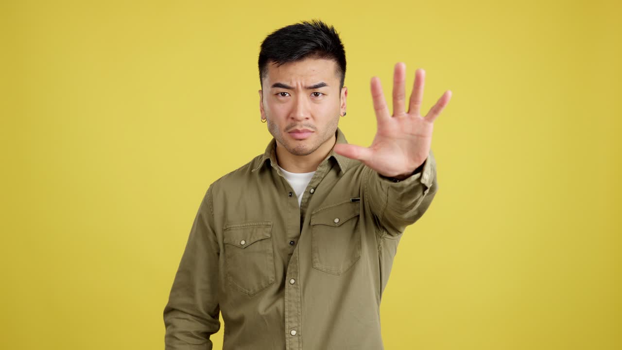 Man making a stop gesture with a serious expression