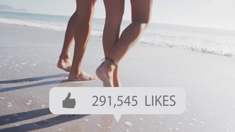 Animation-of-speech-bubble-with-thumbs-up-icon-and-numbers,-low-section-of-couple-walking-on-beach
