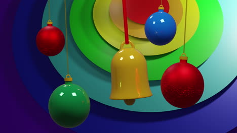 swinging colourful christmas baubles over rainbow coloured rings