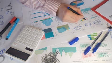 hand of accountant is counting financial report on calculator closeup