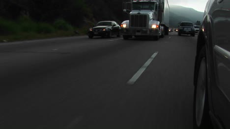 cars and trucks drive by on a crowded highway