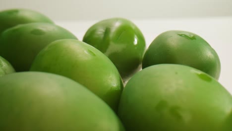 pickled round green olives from greece as background, top view. high quality 4k footage