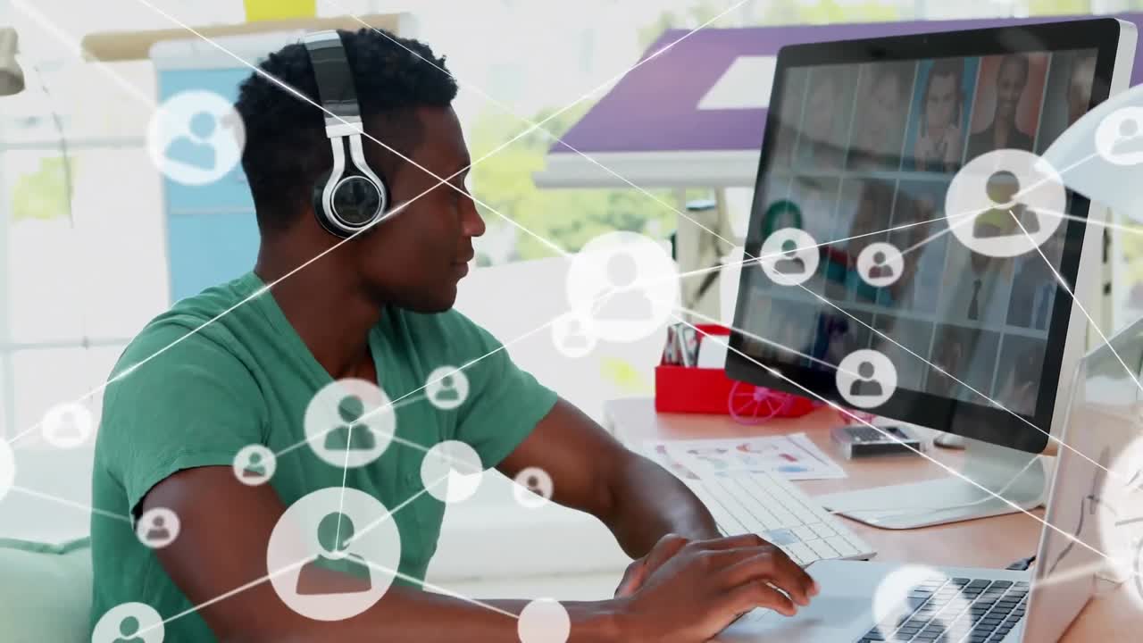 Animation of network of profile icons over african american male graphic designer using laptop