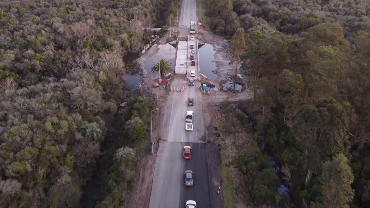 건설 현장에서 다리를 건너기 위해 기다리는 일몰 시 시골 도로에서 공중 비행 교통 체증