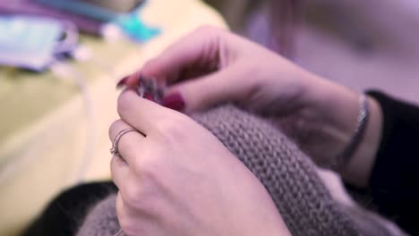 woman knitting a grey sweater