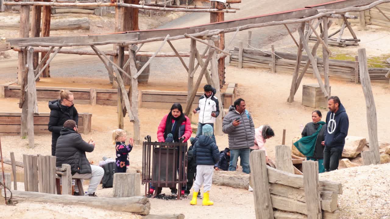 Group of people socializing around a fire pit