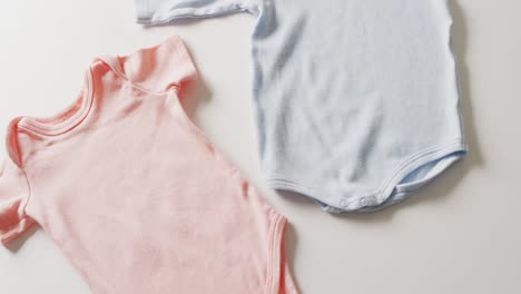 Video-of-close-up-of-blue-and-pink-baby-grows-on-white-background