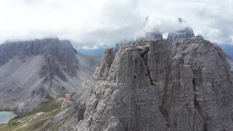 mountain climber ascending torre di toblin mountain peak in tre cime di lavaredo area of dolomites, italy