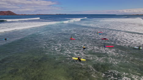 surfers on the waves popular surfing beach in canary islands