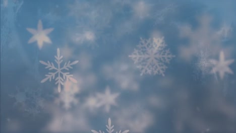 snowflakes moving against blue background