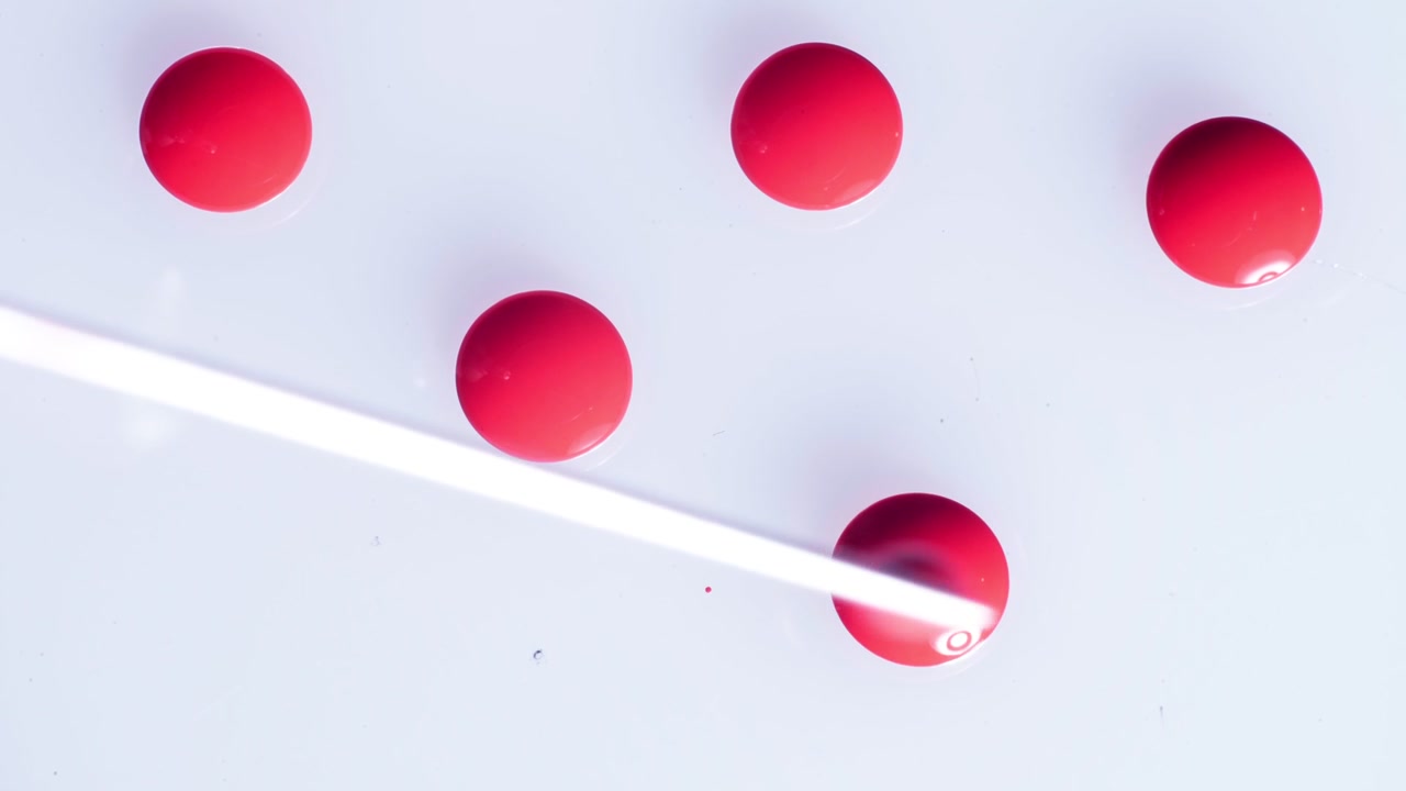 Laboratory analysis of human blood samples being prepared in a petri dish, shown in a sterile top-down view with clinical bright lighting.