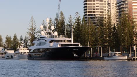 a large yacht moves along a city's waterfront area