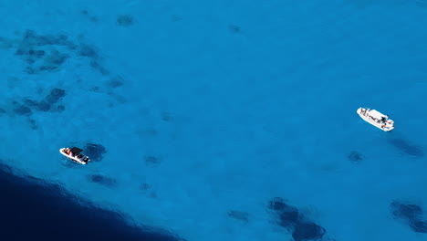 boats on calm deep blue water