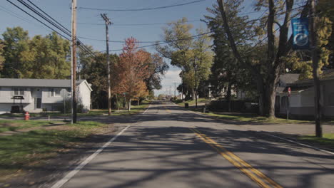 Drive-through-a-typical-American-suburb-as-seen-from-the-rear-window-of-a-car.-4k-window-plate---USA-road-trip