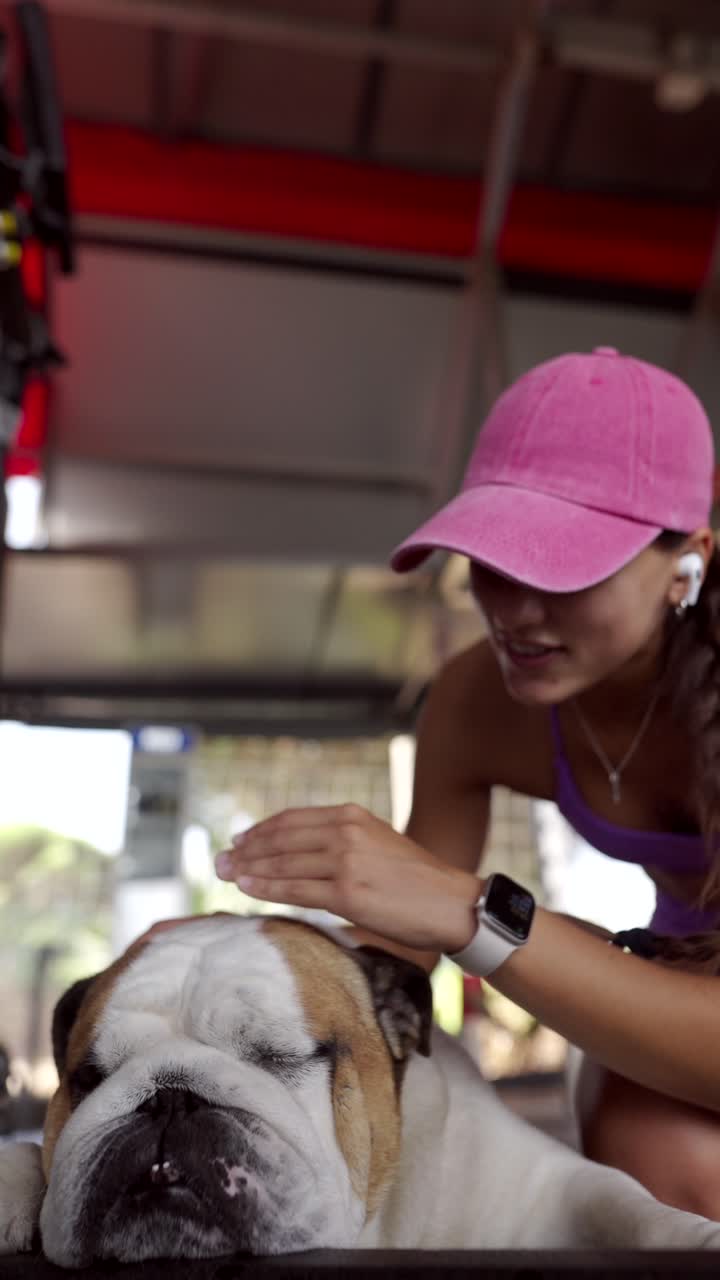 Woman Petting Her Bulldog