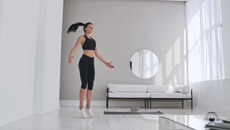 Woman-doing-jumping-jacks-at-home.-Sportswoman-doing-jumping-jacks-exercise-at-home