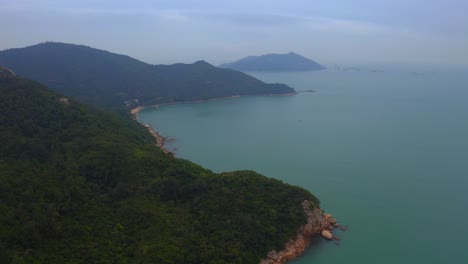 drone-shot-of-a-mountain-coast-full-of-vegetation-and-cliffs-during-the-day