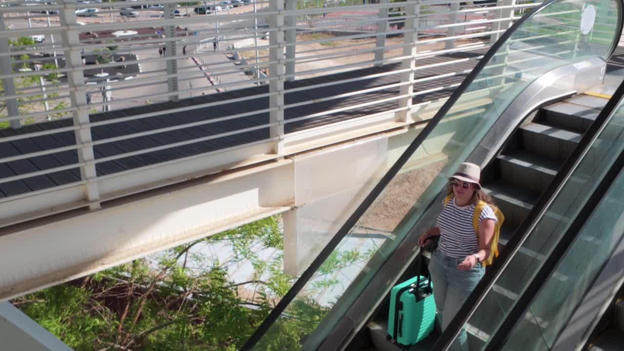 Female Traveler Descending Escalator