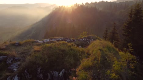 Drone-footage-of-Rucar,-a-Romanian-village-showcasing-autumn-foliage-and-hill-scenery