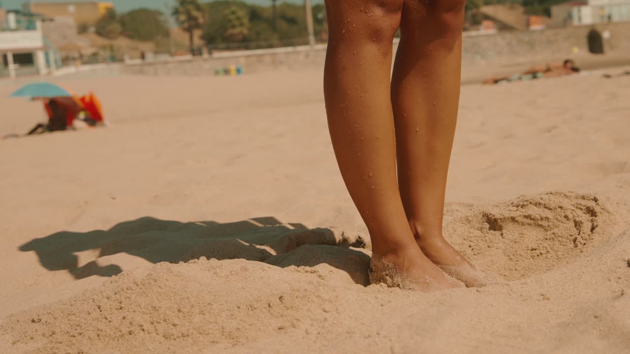 Legs on a sandy beach