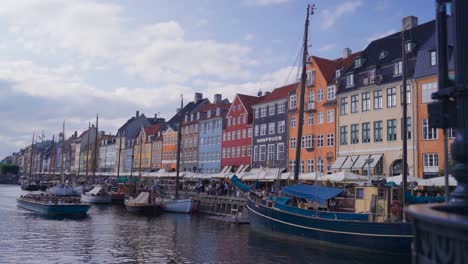boats parked near colorful waterfront nyhavn canal buildings, copenhagen