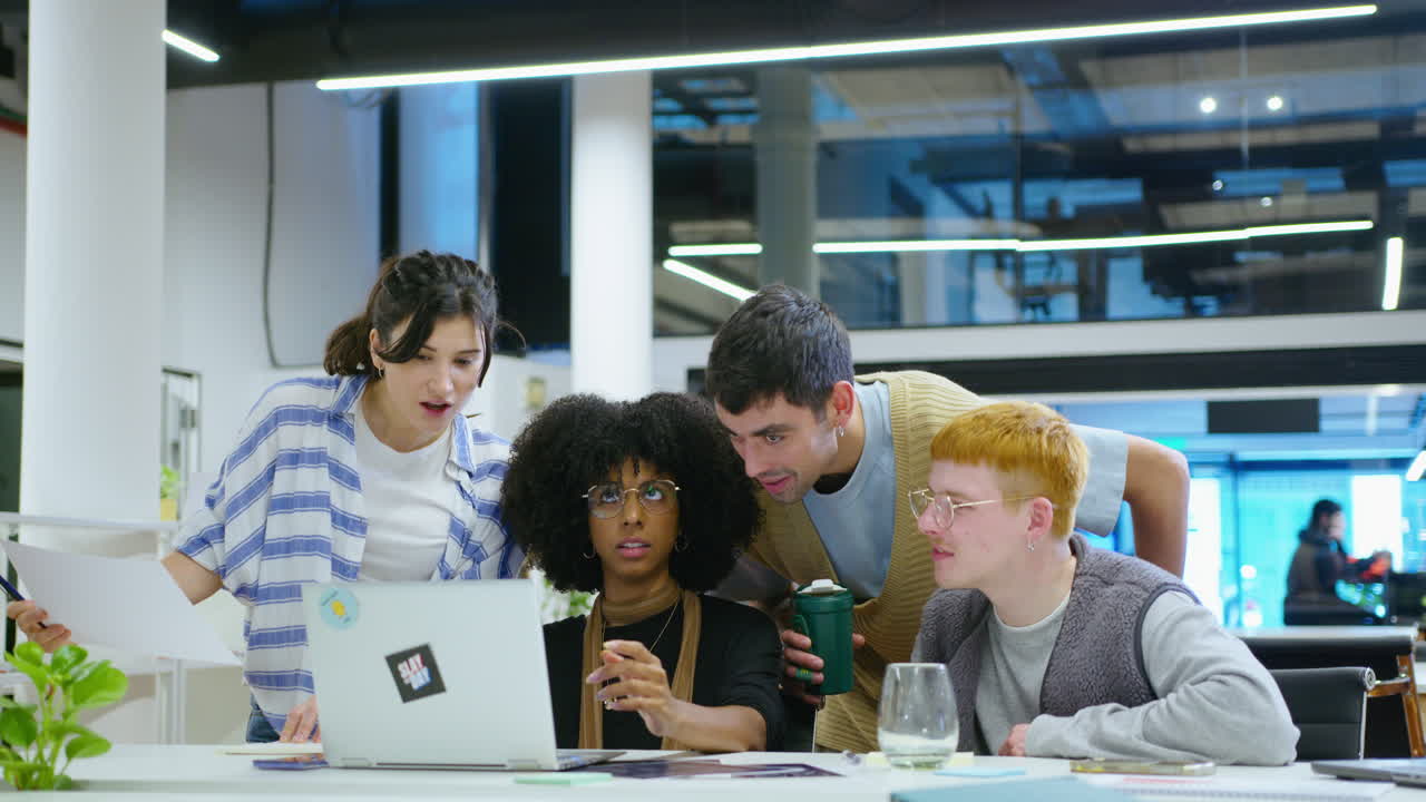 Young Coworkers Using Laptop and Working in Team in the Office