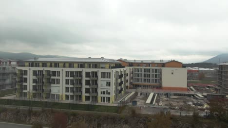 dron shot over some residential buildings, there is a construction site nearby and a crane