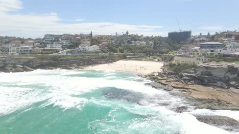 tamarama point with ocean swells - cove beach at tamarama on a sunny day in summer at sydney, nsw, australia