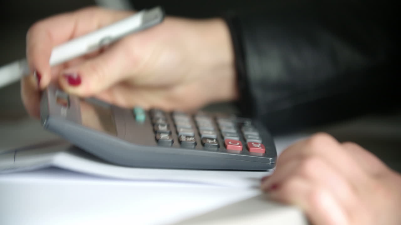 Businesswoman Using A Calculator In Office