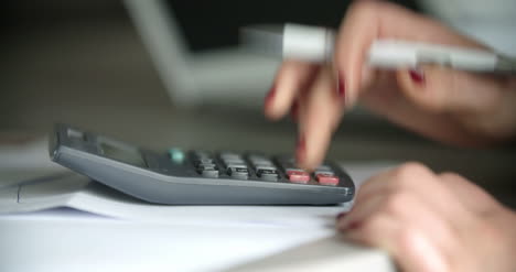 businesswoman using a calculator in office