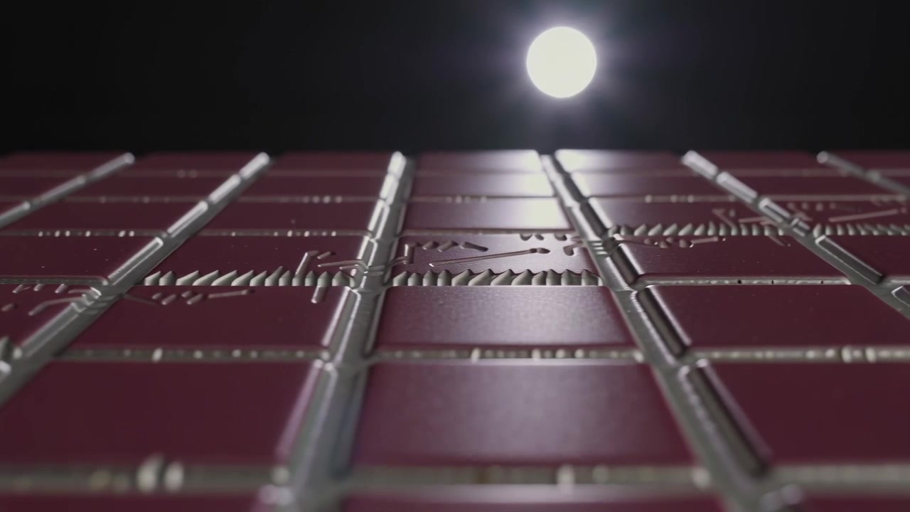 Dollying camera racking focus over glossy red tiles at set, revealing metal seams, chain, spotlight