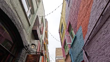 vibrant alleyway with shops and people