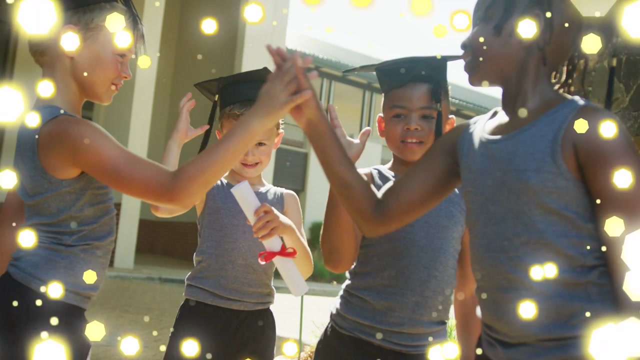 Receiving diplomas, students exchanging high-fives outside school, gold bokeh floating over caps