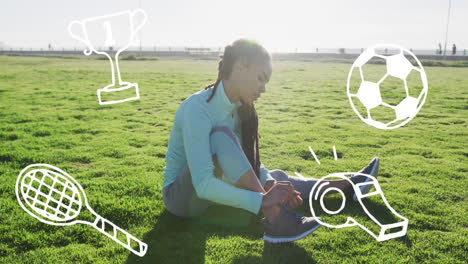 sports concept icons against african american fit woman tying her shoe laces sitting on the grass