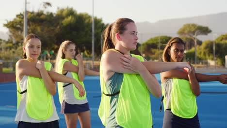 group of girl hockey players stretching