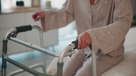 elderly woman using a walker to get out of bed