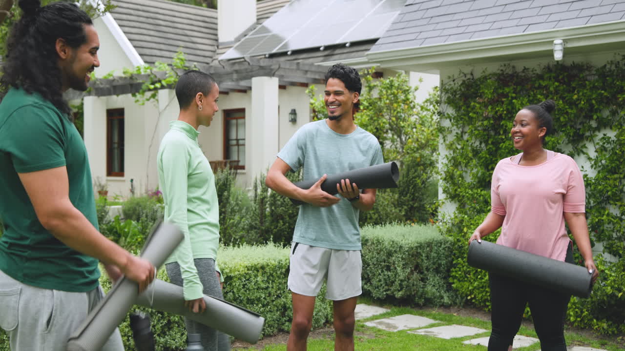 diverse friends gathering outdoors holding yoga mats, smiling and enjoying day