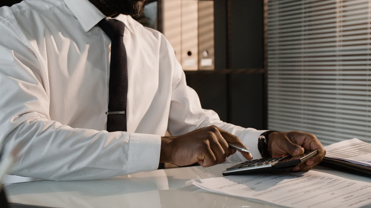 Businessman Calculating Finances in Office