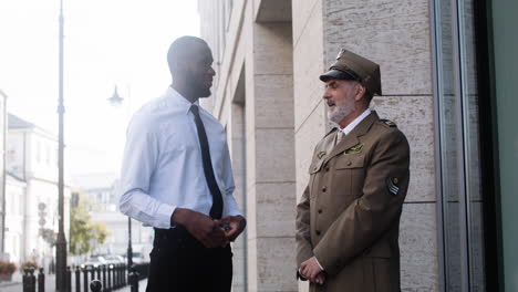 two men talking on the street