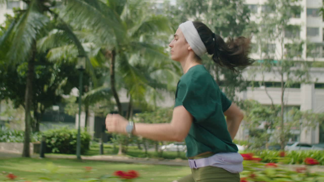 Female Runner Jogging along City Street