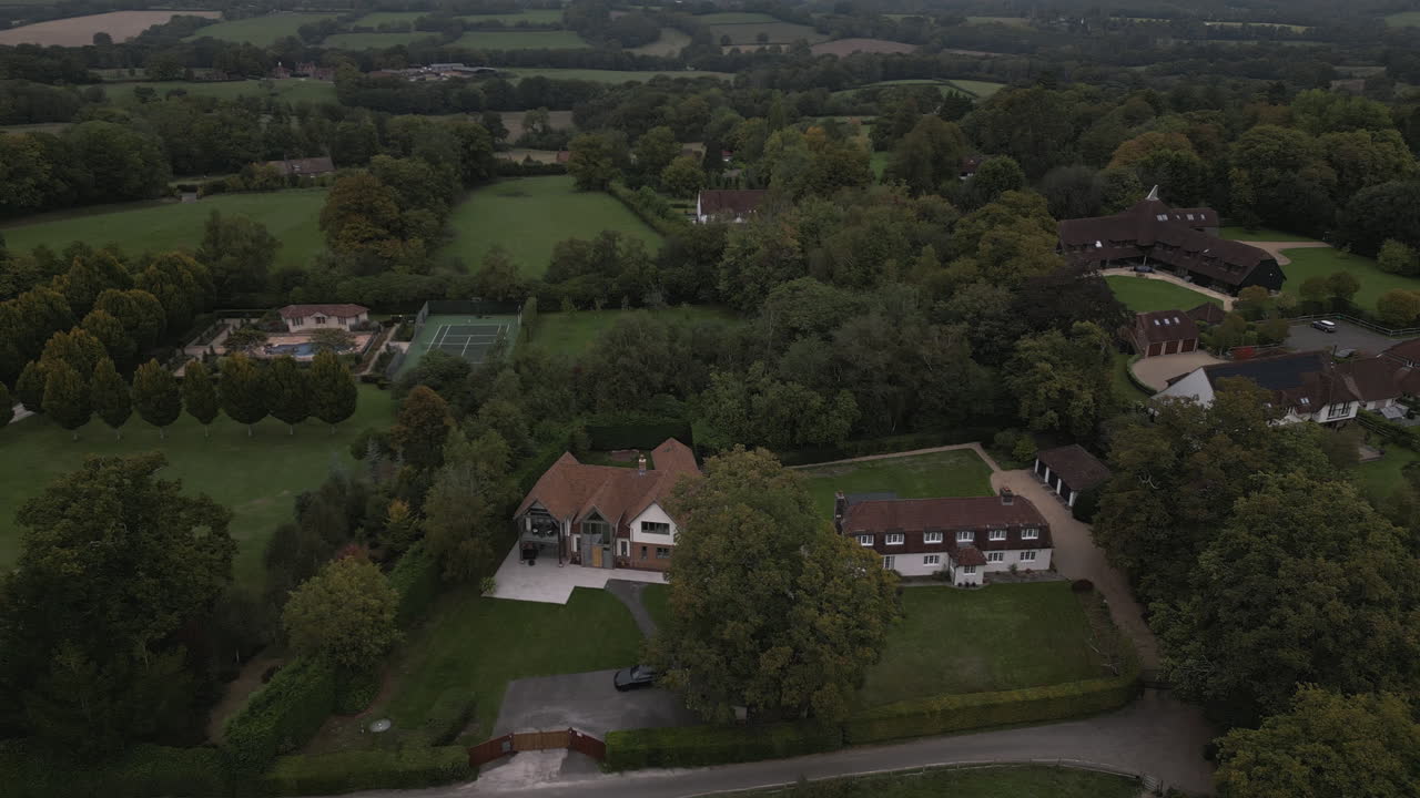 Luxury homes surrounded by green landscape, aerial view