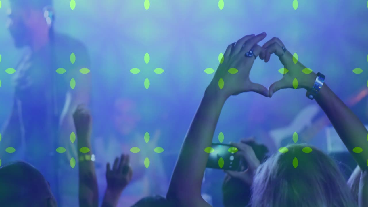 Publikum danser til koncert mod hypnotisk bevægelsesbaggrund