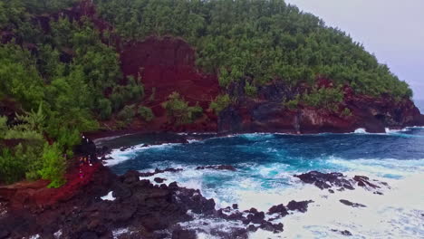 Drone-dolley-shot-of-high-waves-rooling-at-the-rocky-shore-in-Hawaii