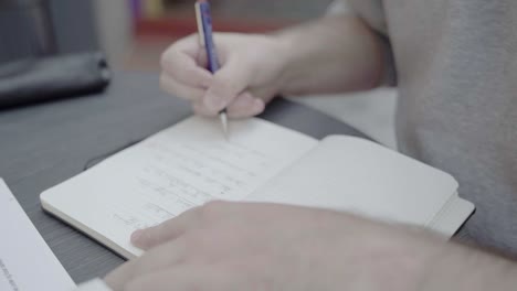a male student taking notes by hand