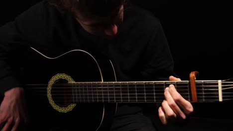 man strumming a guitar in a studio