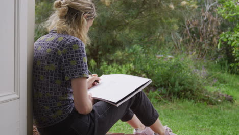 woman drawing in a garden