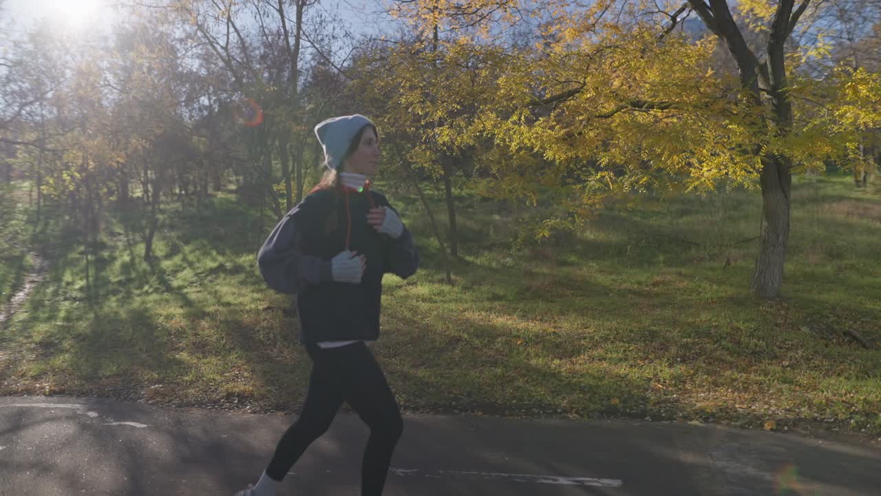 Woman Running in Autumn Park