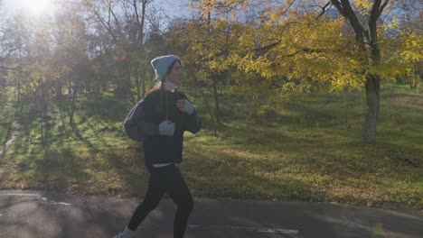 woman running in autumn park